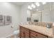 Bathroom with a single sink, granite counters, wood cabinetry, and a mirror at 10029 S 44Th St, Phoenix, AZ 85044