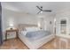 Bright primary bedroom with a ceiling fan, neutral walls, and warm toned floors at 10029 S 44Th St, Phoenix, AZ 85044