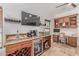 Stylish bar area with wine storage, granite countertops, and custom wood cabinets. Includes a beverage refrigerator at 10029 S 44Th St, Phoenix, AZ 85044