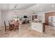 Bright kitchen with a breakfast bar, stainless steel appliances, custom wood cabinets, and travertine floors at 10029 S 44Th St, Phoenix, AZ 85044