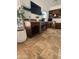 Stylish living area with a built-in bar, wine rack, mini fridge, granite counters and adjacent desk area at 10029 S 44Th St, Phoenix, AZ 85044