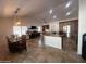 Open-concept living room with a large island, stainless steel appliances, and dining area with a decorative light fixture at 10029 S 44Th St, Phoenix, AZ 85044