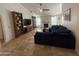 Spacious living room with tile floors, a stone fireplace, large sectional sofa, and built-in shelving at 10029 S 44Th St, Phoenix, AZ 85044