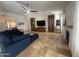 Open living room with travertine flooring, built-in bookshelves, and a stacked stone fireplace creates a cozy and elegant space at 10029 S 44Th St, Phoenix, AZ 85044