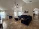 Inviting living room featuring stone fireplace, plush seating, and views of the pool through bright, sheer-curtained windows at 10029 S 44Th St, Phoenix, AZ 85044
