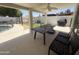 Covered patio with dining table and view of the pool, playhouse and playground area, perfect for outdoor living at 10029 S 44Th St, Phoenix, AZ 85044