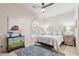 This bedroom features neutral tones, a ceiling fan, and tile flooring at 10420 E Morning Vista Ln, Scottsdale, AZ 85262