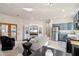 Open-concept living room features modern furnishings, a large TV, and seamless flow to the kitchen at 10420 E Morning Vista Ln, Scottsdale, AZ 85262