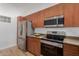 Updated kitchen features stainless steel appliances and wooden cabinets at 11640 N Tatum Blvd # 2012, Phoenix, AZ 85028