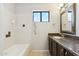 Bathroom showcases tub with tile, granite countertop, and framed mirror at 1192 E Sunset Dr, Casa Grande, AZ 85122