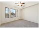 Bright carpeted bedroom with multiple windows providing natural light and a high vaulted ceiling with fan at 1192 E Sunset Dr, Casa Grande, AZ 85122