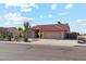 Beautiful single-story home with a red tile roof, lush landscaping, and an attached two-car garage at 1192 E Sunset Dr, Casa Grande, AZ 85122