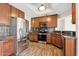 Modern kitchen featuring stainless steel appliances, granite countertops, and wood cabinetry at 1192 E Sunset Dr, Casa Grande, AZ 85122