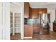 Well-equipped kitchen area showing stainless steel appliances, wood cabinets, and a pantry at 1192 E Sunset Dr, Casa Grande, AZ 85122