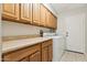 Well-lit laundry room with built-in cabinets, a countertop, and modern washer and dryer at 1192 E Sunset Dr, Casa Grande, AZ 85122