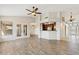 Expansive living area showcasing wood-look floors, access to the kitchen, and ample natural light at 1192 E Sunset Dr, Casa Grande, AZ 85122