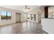 Open living area with wood floors, a ceiling fan, and access to the backyard at 1192 E Sunset Dr, Casa Grande, AZ 85122