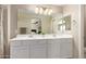 Bathroom vanity with double sinks, a large mirror, and white cabinets at 125 N Sunvalley Blvd # 119, Mesa, AZ 85207