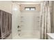 Bathroom with a shower and tub combination with white tile surround and shower curtain at 125 N Sunvalley Blvd # 119, Mesa, AZ 85207