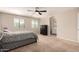 Bright bedroom with ceiling fan, neutral carpet and bathroom access at 125 N Sunvalley Blvd # 119, Mesa, AZ 85207