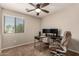 Bedroom featuring a ceiling fan, large window and neutral walls, creating a bright and airy workspace at 125 N Sunvalley Blvd # 119, Mesa, AZ 85207