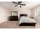 Cozy bedroom with ceiling fan, carpet, and dark wood bedroom set at 125 N Sunvalley Blvd # 119, Mesa, AZ 85207