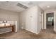 Hallway featuring carpeted floors and walls. There is a table with a lamp on it at 125 N Sunvalley Blvd # 119, Mesa, AZ 85207