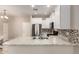 Kitchen with stainless steel appliances, white cabinets, and stylish tile backsplash at 125 N Sunvalley Blvd # 119, Mesa, AZ 85207