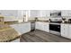 Clean kitchen featuring white cabinets, stainless steel appliances, and stone countertops at 12852 N Mountainside Dr # 2, Fountain Hills, AZ 85268
