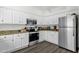 Modern kitchen with white cabinetry, stainless appliances and wood-look flooring at 12852 N Mountainside Dr # 2, Fountain Hills, AZ 85268