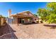 Home exterior featuring a covered patio, stone landscaping, and paved walkway with backyard views at 1379 E Butler Cir, Chandler, AZ 85225