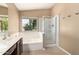 Bright bathroom featuring a separate tub and shower, and a window bringing natural light into the space at 1379 E Butler Cir, Chandler, AZ 85225
