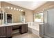Bathroom features dual sinks, a bathtub, and a glass-enclosed shower at 1379 E Butler Cir, Chandler, AZ 85225