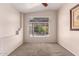Bedroom features a ceiling fan and large window looking out to a covered patio at 1379 E Butler Cir, Chandler, AZ 85225