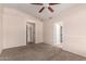 Spacious carpeted bedroom features a ceiling fan and two entrances to bathrooms at 1379 E Butler Cir, Chandler, AZ 85225