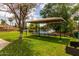 View of the community picnic area with tables, mature trees, and a view of the pond at 1379 E Butler Cir, Chandler, AZ 85225