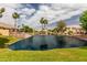 Scenic view of the community pond surrounded by mature trees and lush landscaping at 1379 E Butler Cir, Chandler, AZ 85225