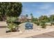 The Springs Swim and Racquet Club entrance surrounded by mature trees and manicured landscaping at 1379 E Butler Cir, Chandler, AZ 85225