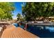 An inviting waterfront view with a private wooden dock, serene canal, and lush landscaping enhancing outdoor appeal at 1379 E Butler Cir, Chandler, AZ 85225