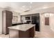 Modern kitchen featuring stone countertops, a kitchen island, tile flooring, and ample cabinet space at 1379 E Butler Cir, Chandler, AZ 85225