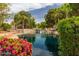 Beautiful community pond featuring a waterfall and lush landscaping at 1379 E Butler Cir, Chandler, AZ 85225