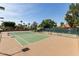 Brightly lit tennis court with shade trees creates a vibrant space for recreational activities at 1379 E Butler Cir, Chandler, AZ 85225