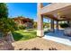View of home from backyard showing trampoline, patio, pool, and colorful bougainvillea bush at 15792 W Desert Mirage Dr, Surprise, AZ 85379