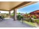 Covered balcony with a view of the nearby neighborhood; has an outdoor dining set at 15792 W Desert Mirage Dr, Surprise, AZ 85379