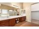 Large bathroom with double vanity, lots of counter space, mirrors, and tile flooring at 15792 W Desert Mirage Dr, Surprise, AZ 85379