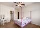 Cozy bedroom with a bed, fan, and closet at 15792 W Desert Mirage Dr, Surprise, AZ 85379