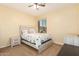 Guest bedroom featuring a full size bed, ceiling fan, and a cozy ambiance at 15792 W Desert Mirage Dr, Surprise, AZ 85379