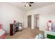 Neutral bedroom staged as playroom with open door to closet and view to hallway with another doorway at 15792 W Desert Mirage Dr, Surprise, AZ 85379
