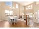 Spacious dining room with chandelier, large windows, and tile flooring, creating an elegant setting at 15792 W Desert Mirage Dr, Surprise, AZ 85379