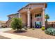 Beautiful two-story home with large front porch, a three-car garage, and mature landscaping at 15792 W Desert Mirage Dr, Surprise, AZ 85379